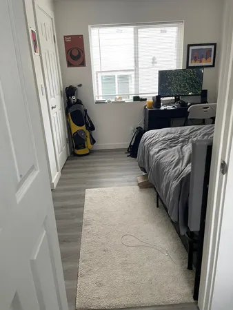 a bedroom with a bed and a flat tv screen on the dresser