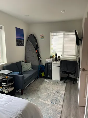 a living room with furniture a window and a dresser