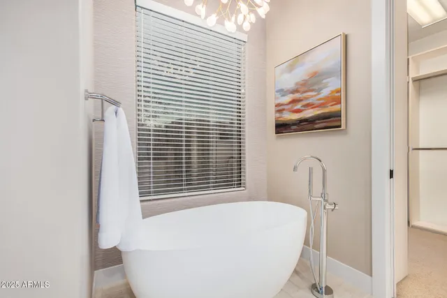 a bathroom with a bathtub and a window