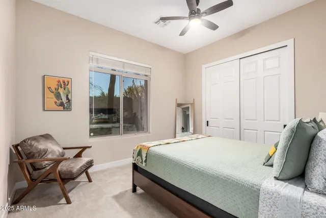 a bedroom with a bed and chair