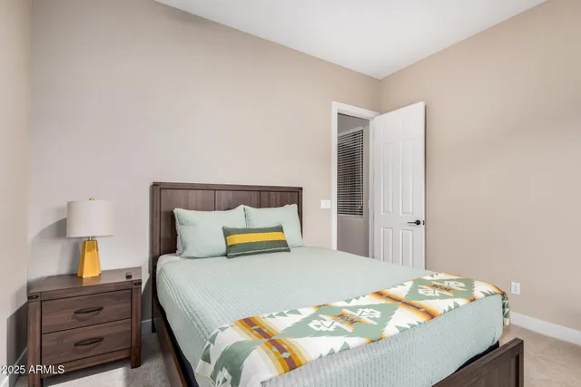 a bedroom with a bed and dressers