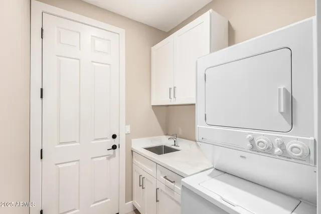 a kitchen with white cabinets and white appliances