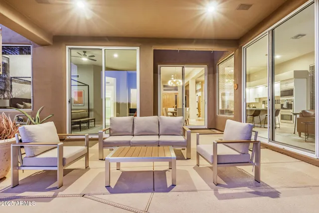 a living room with furniture and large windows