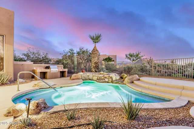 a view of a swimming pool with an outdoor seating