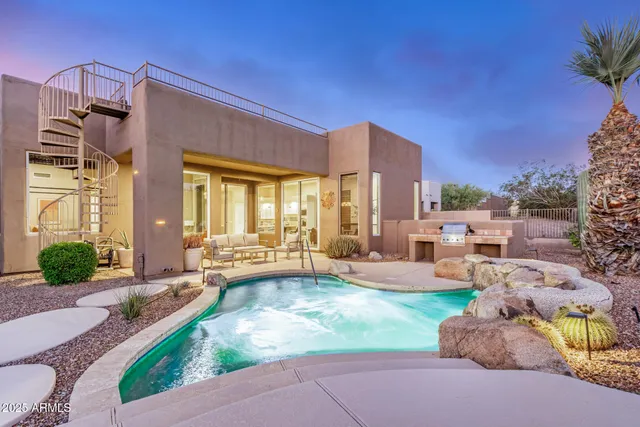 a swimming pool with outdoor seating and yard
