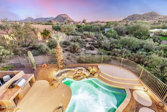 a view of a swimming pool with a table and chairs