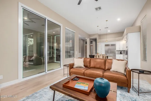 a living room with furniture and a glass door