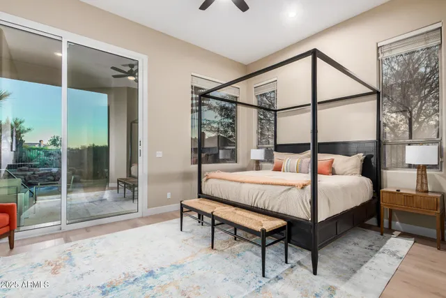 a bedroom with a bed and large glass window