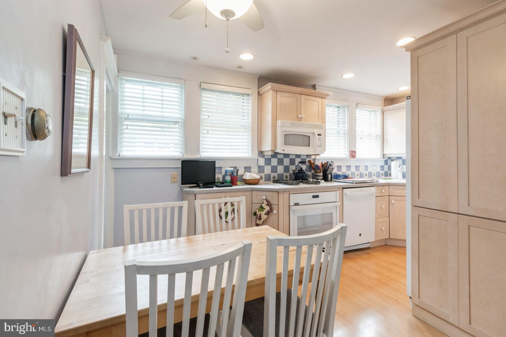 400 Maple Avenue Haddonfield, NJ 08033 - Photo 8 of 31 a kitchen with stainless steel appliances granite countertop a refrigerator a stove a sink dishwasher and white cabinets with wooden floor