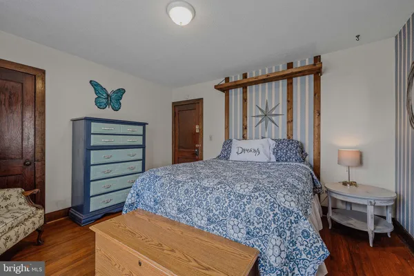 a bedroom with a bed and a dresser