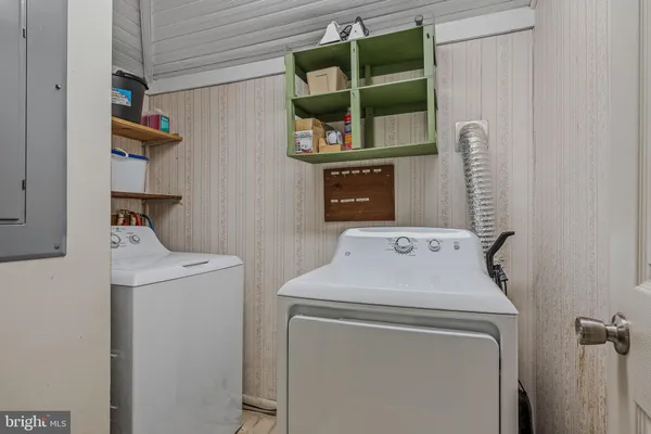 a backyard of a house with barbeque oven table and chairs