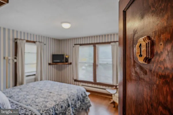 a bedroom with a bed and a television