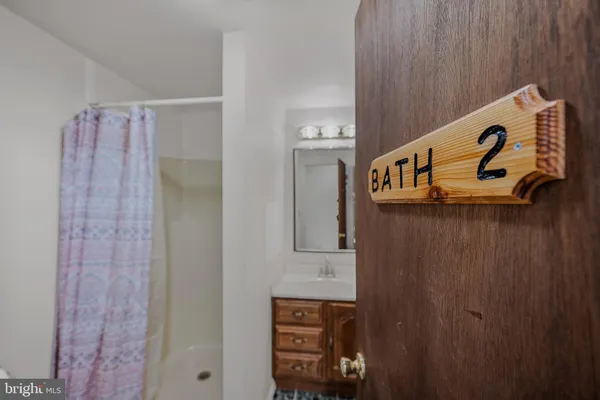 a bedroom with a bed window and a chair