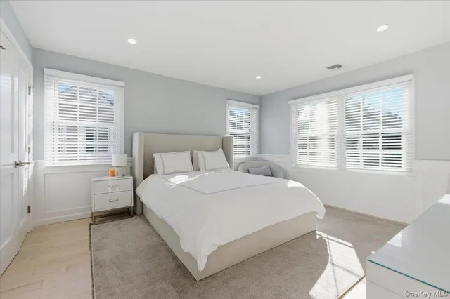 a bedroom with furniture and a window