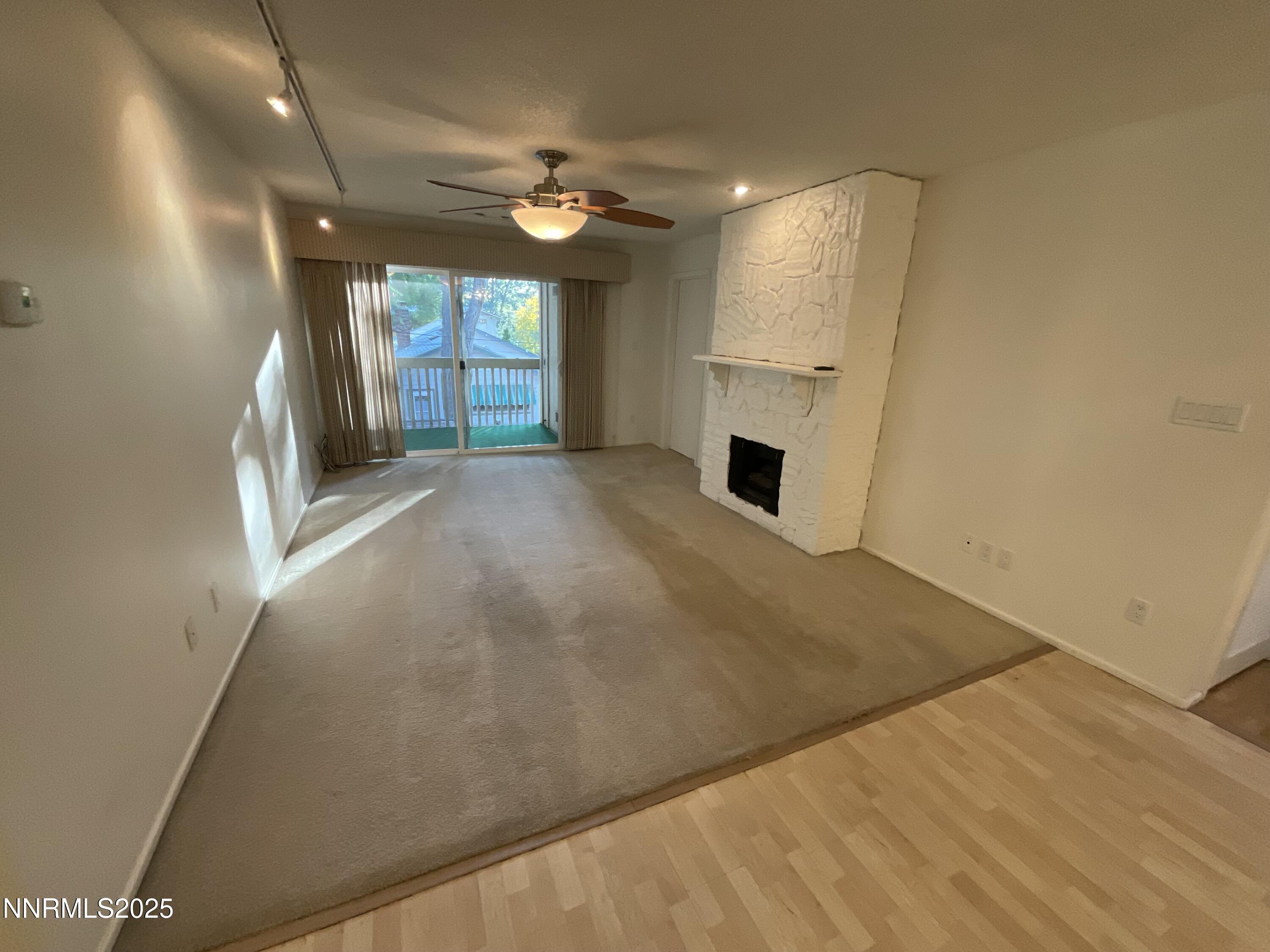 2300 Dickerson Road, Unit 8 Reno, NV 89503 - Photo 2 of 18 an empty room with chandelier fan and windows