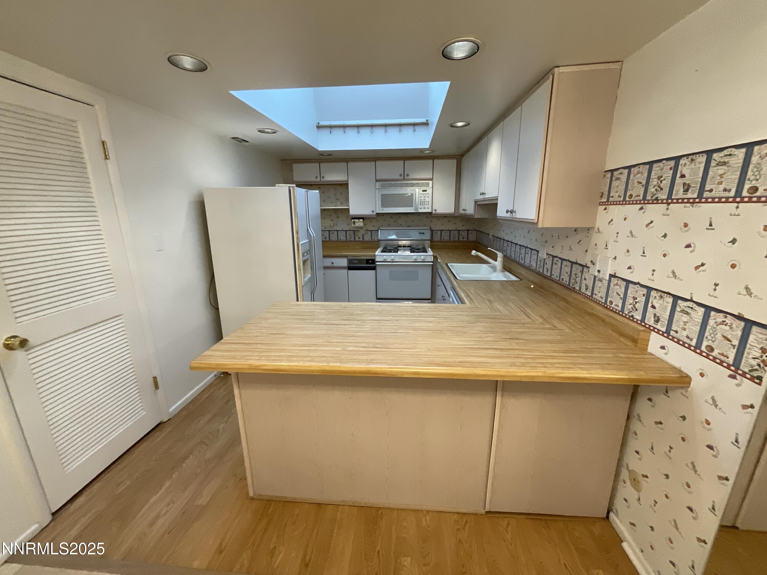 2300 Dickerson Road, Unit 8 Reno, NV 89503 - Photo 3 of 18 a view of a kitchen with furniture and wooden floor