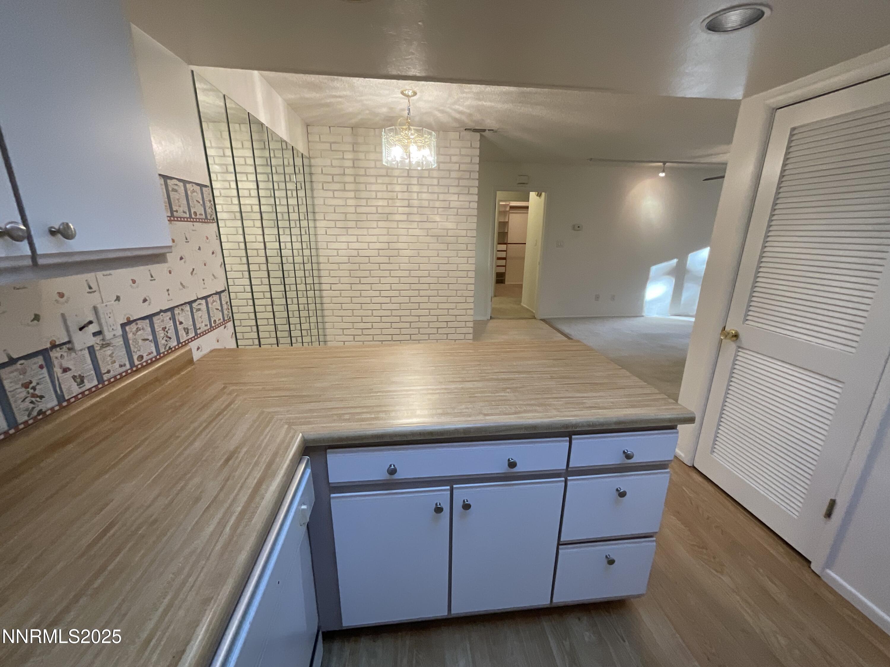2300 Dickerson Road, Unit 8 Reno, NV 89503 - Photo 4 of 18 a view of kitchen with granite countertop white cabinets and wooden floor