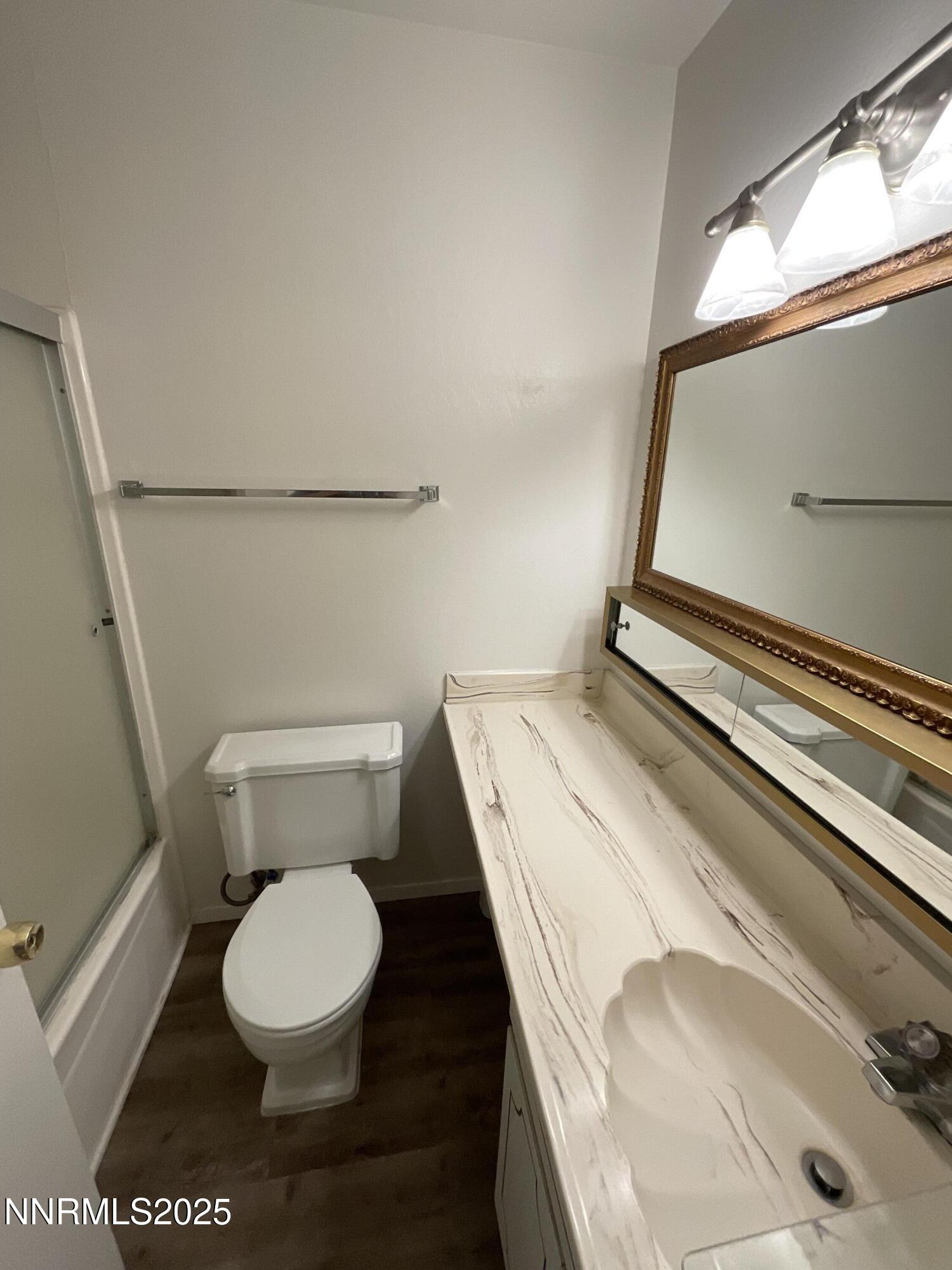 2300 Dickerson Road, Unit 8 Reno, NV 89503 - Photo 7 of 18 a white toilet sitting next to a bathroom sink