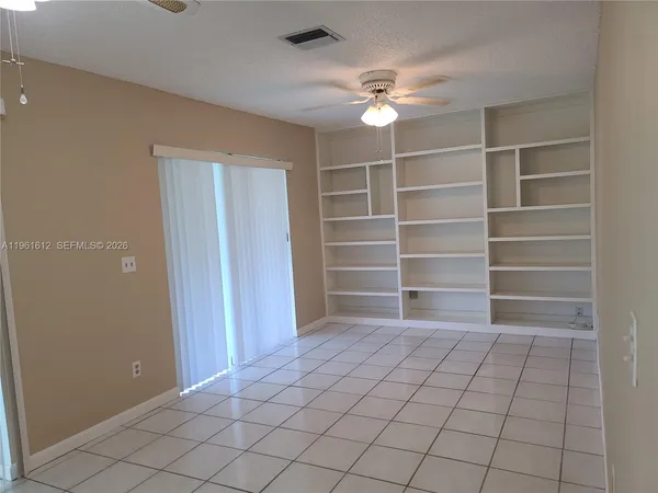 a view of an empty room with a staircase