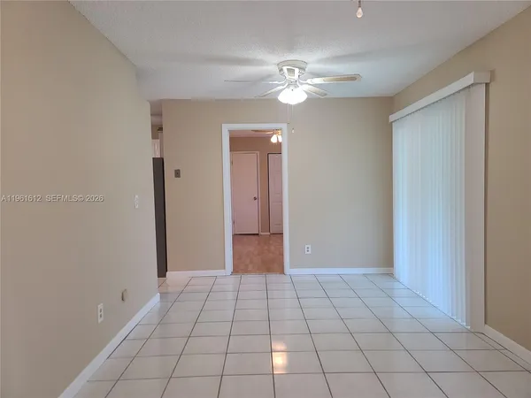 a view of an empty room with bathroom