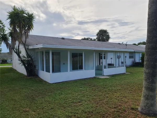 a view of house with a yard