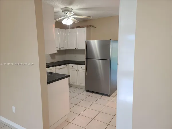a kitchen with stainless steel appliances a refrigerator a sink and a stove