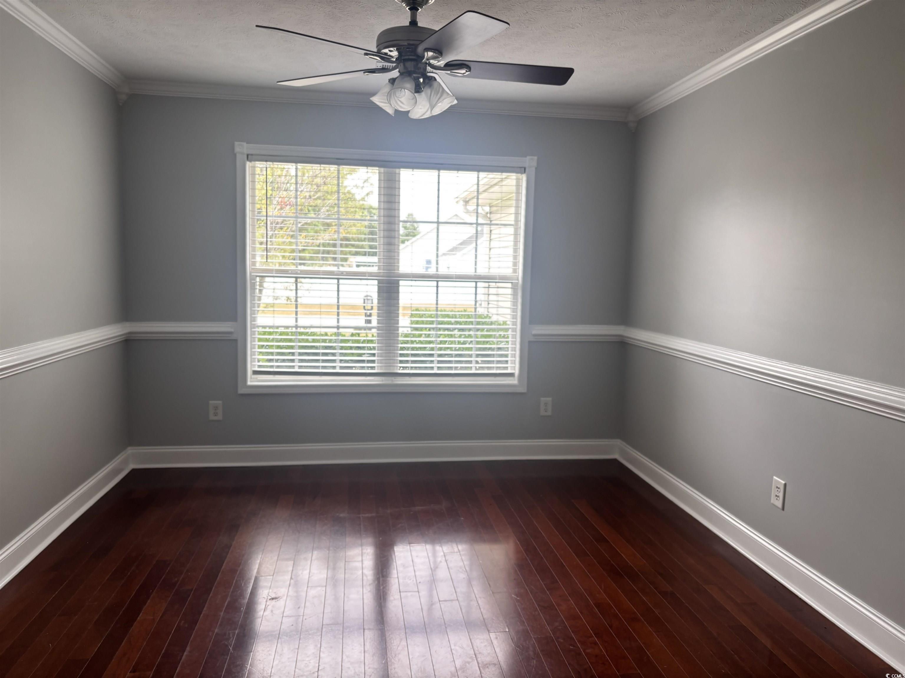 733 Rambler Court Myrtle Beach, SC 29588 - Photo 4 of 10 Dining room featuring dark wood-type flooring, crown molding, a textured ceiling, and ceiling fan