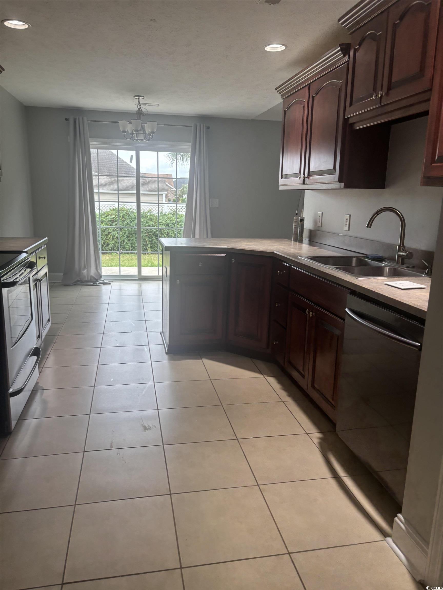 733 Rambler Court Myrtle Beach, SC 29588 - Photo 5 of 10 Kitchen featuring stainless steel range with electric stovetop, light tile patterned flooring, a peninsula, recessed lighting, and dishwashing machine