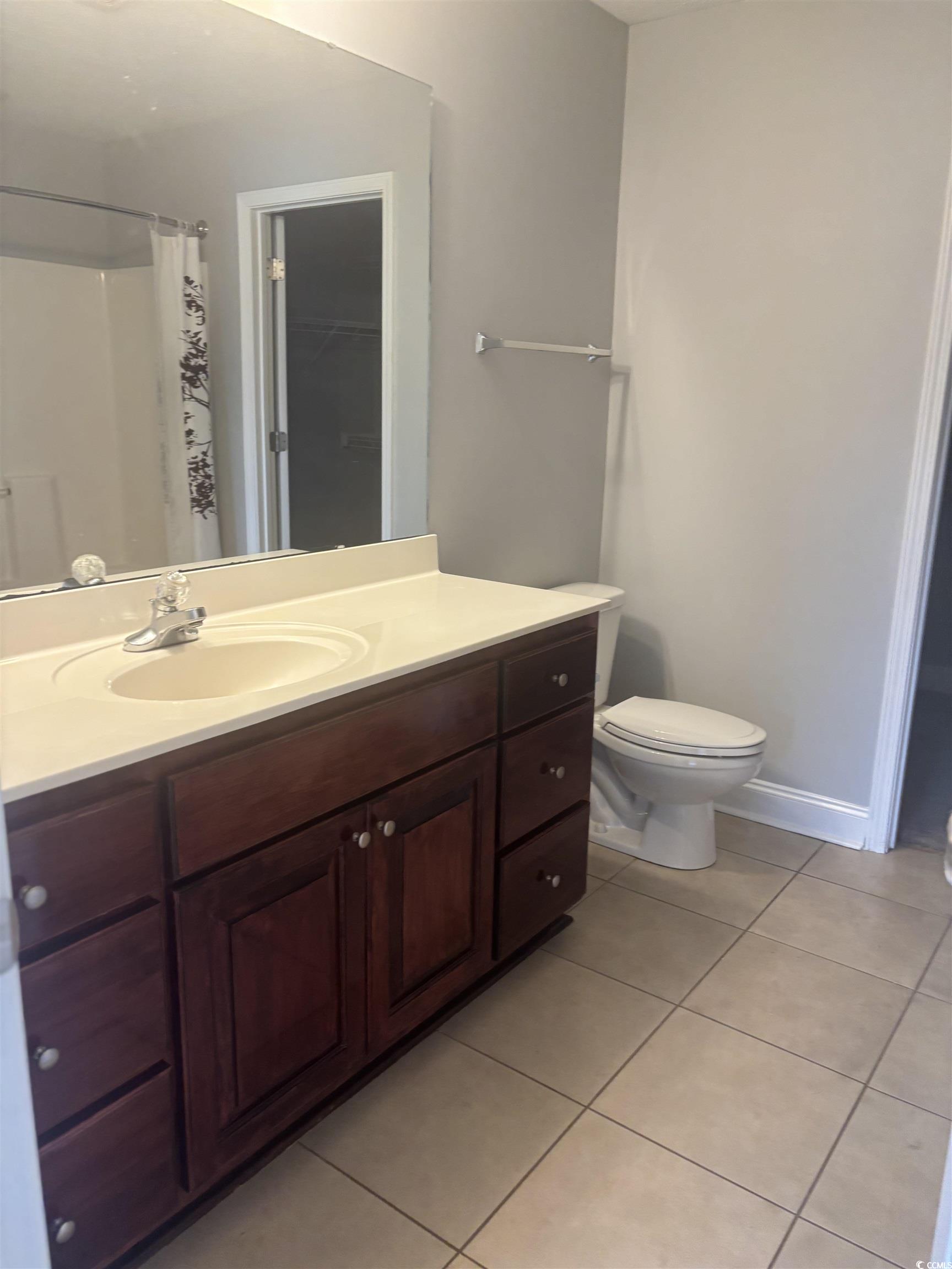 733 Rambler Court Myrtle Beach, SC 29588 - Photo 8 of 10 Bathroom featuring light tile patterned floors, vanity, and curtained shower