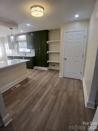 a view of a kitchen with a sink and a refrigerator