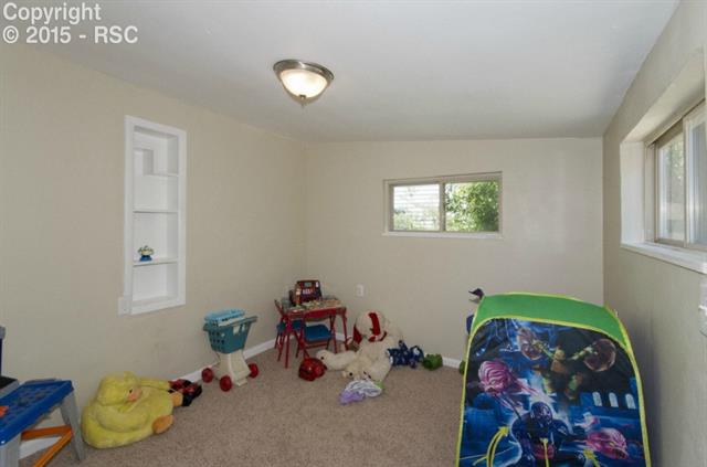 615 Sunset Road Colorado Springs, CO 80909 - Photo 10 of 20 This is a nice sized bedroom that is currently being used as a play room.