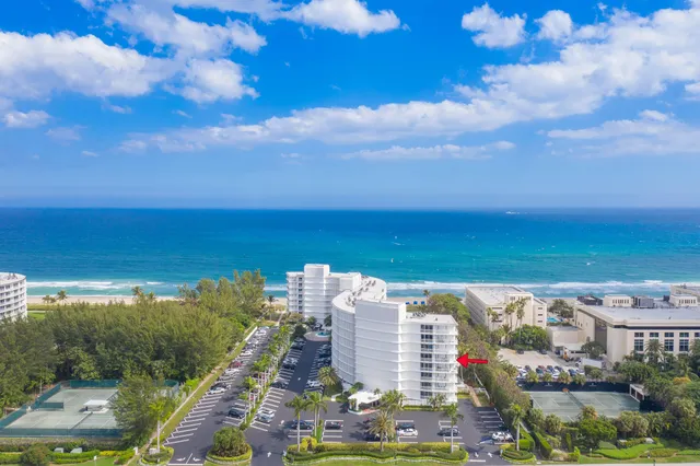 a living room with furniture and a kitchen view