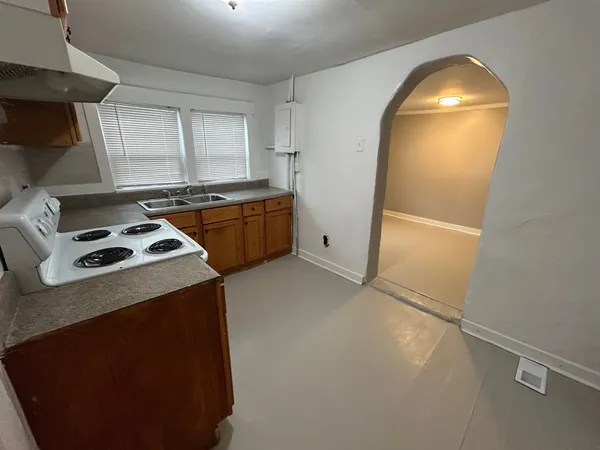 a kitchen that has a sink and a stove