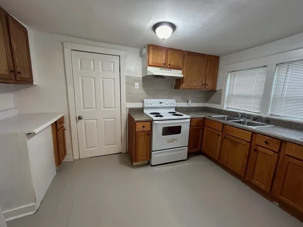 a kitchen with a stove sink and a refrigerator
