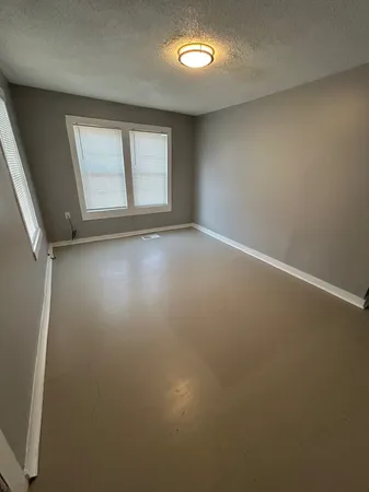 an empty room with a empty space and windows