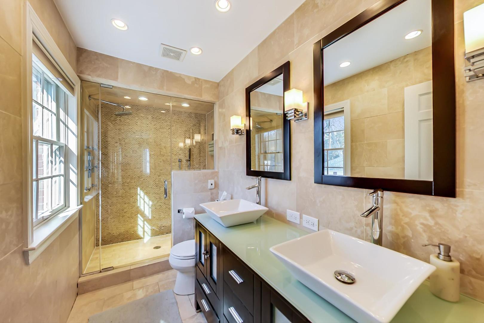 206 Green Bay Road Winnetka, IL 60093 - Photo 23 of 45 a bathroom with a sink double vanity and a mirror