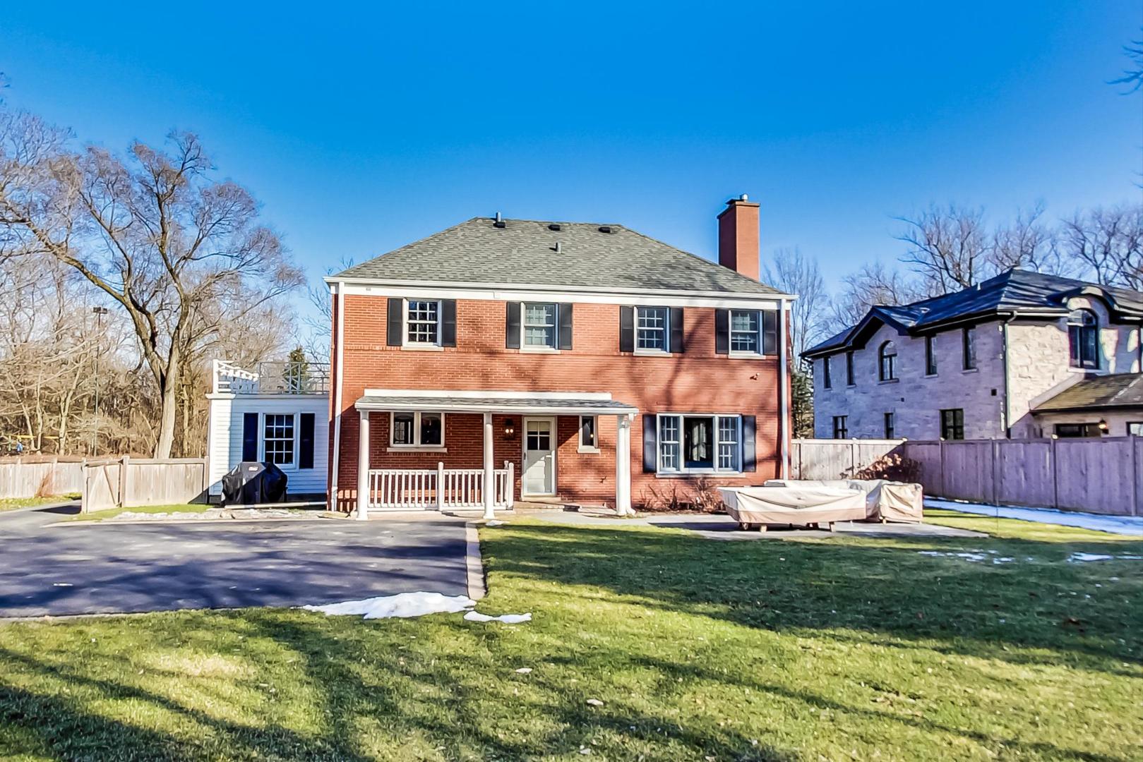 206 Green Bay Road Winnetka, IL 60093 - Photo 38 of 45 a front view of a house with a yard table and chairs