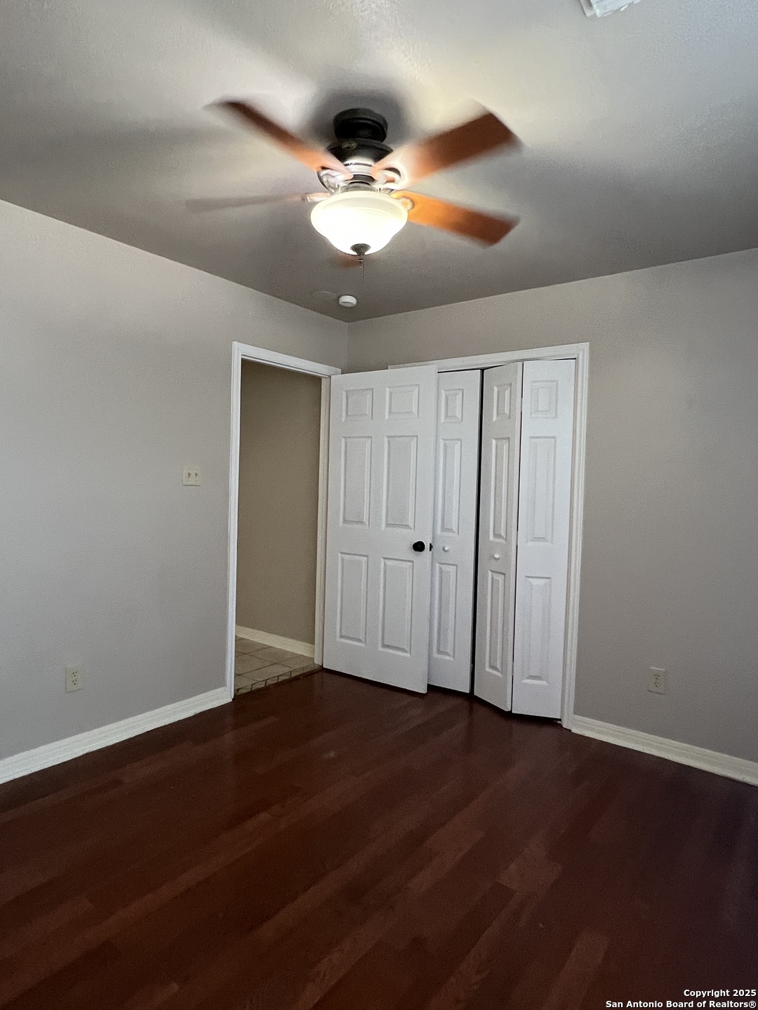 9140 Timber Path, Unit 802 San Antonio, TX 78250 - Photo 13 of 29 a view of an empty room with wooden floor