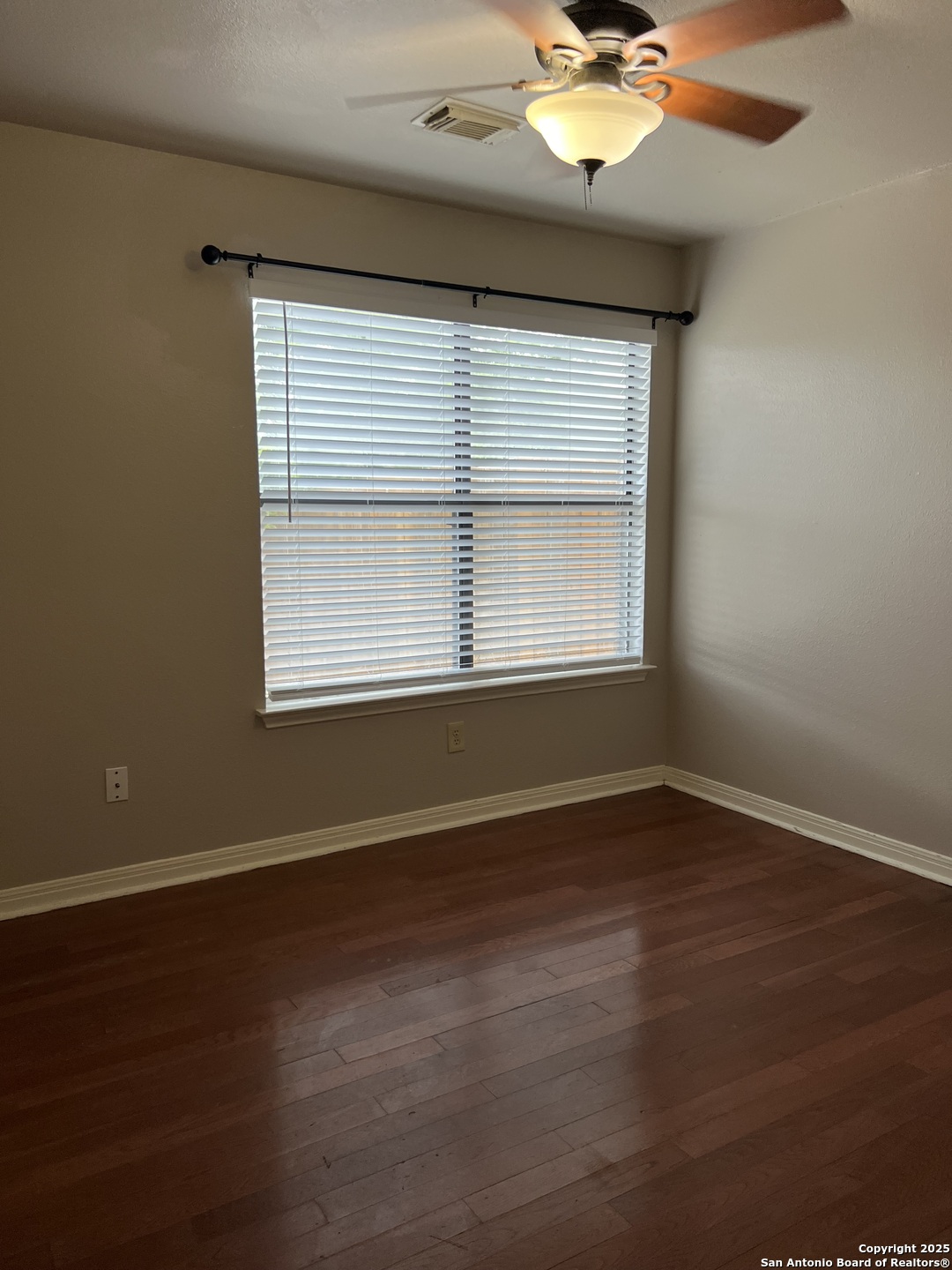 9140 Timber Path, Unit 802 San Antonio, TX 78250 - Photo 14 of 29 a view of an empty room with wooden floor and a window