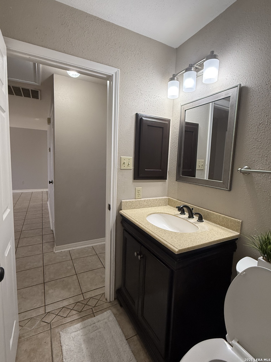 9140 Timber Path, Unit 802 San Antonio, TX 78250 - Photo 15 of 29 a bathroom with a sink a toilet a mirror and shower