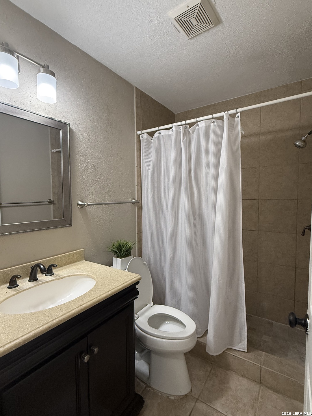 9140 Timber Path, Unit 802 San Antonio, TX 78250 - Photo 16 of 29 a bathroom with a sink a toilet and shower