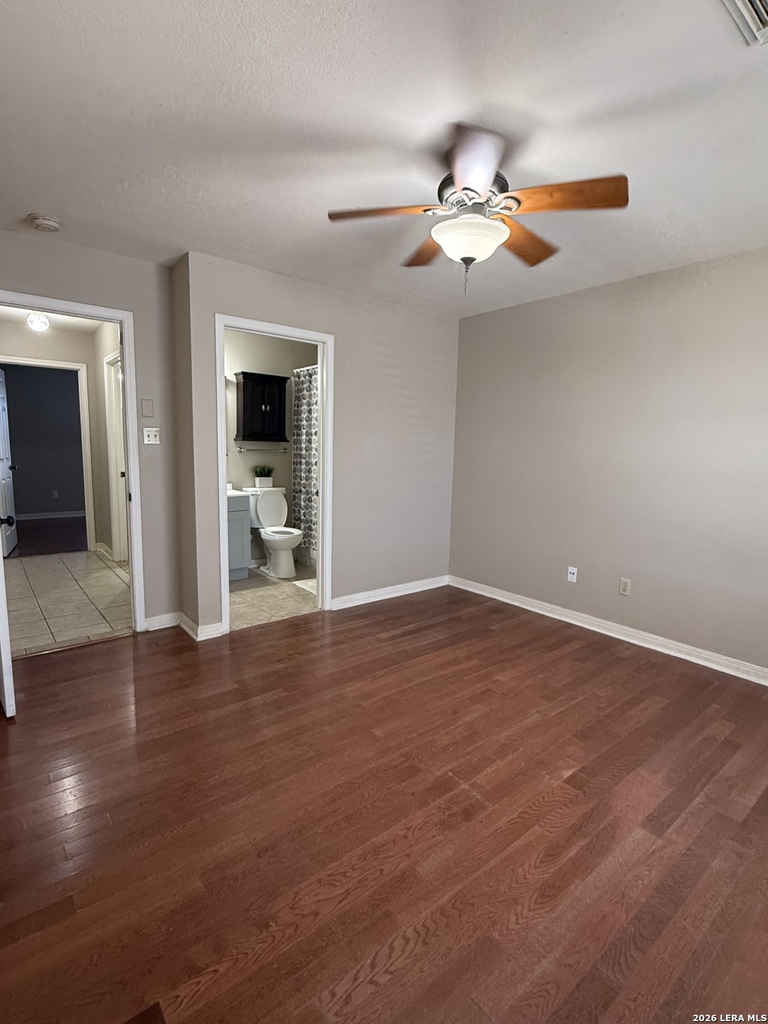 9140 Timber Path, Unit 802 San Antonio, TX 78250 - Photo 19 of 29 an empty room with wooden floor fan and windows