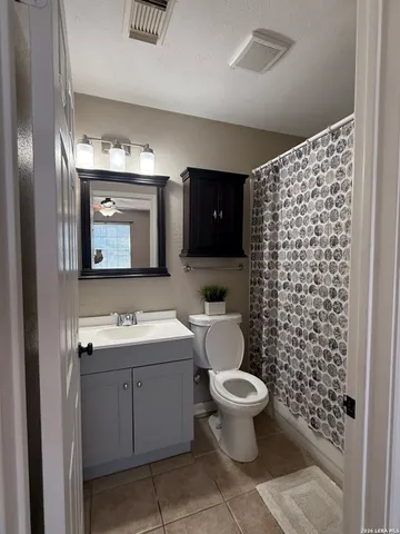 a bathroom with a toilet sink and a mirror