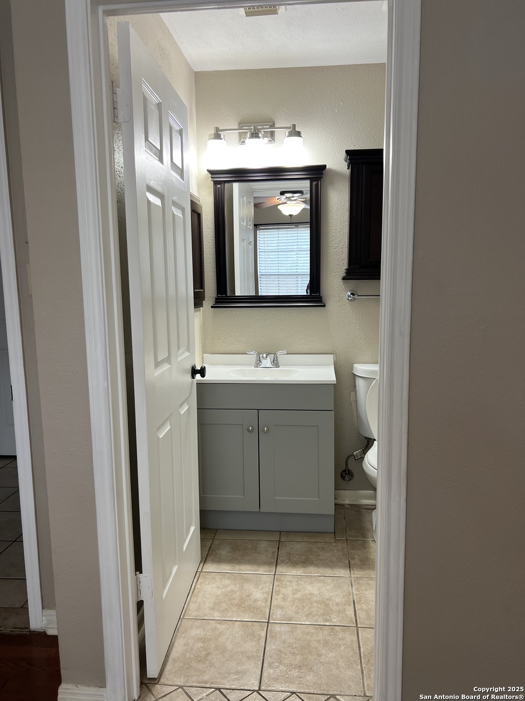 9140 Timber Path, Unit 802 San Antonio, TX 78250 - Photo 22 of 29 a bathroom with a sink and a mirror