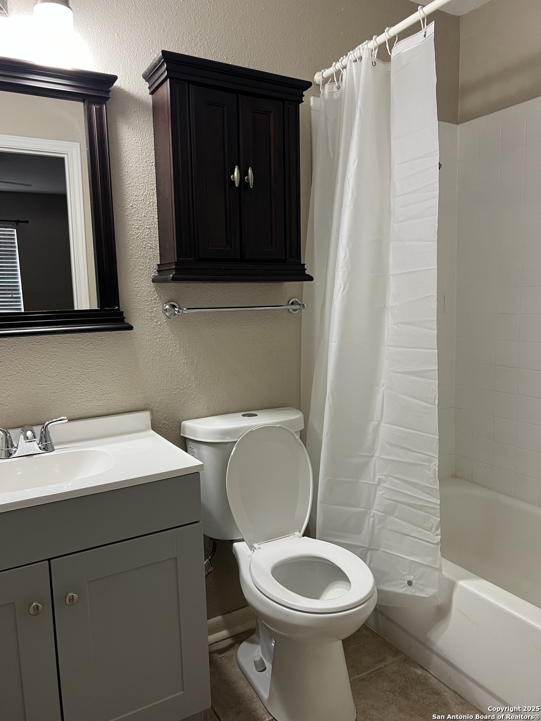 9140 Timber Path, Unit 802 San Antonio, TX 78250 - Photo 23 of 29 a bathroom with a toilet sink and mirror