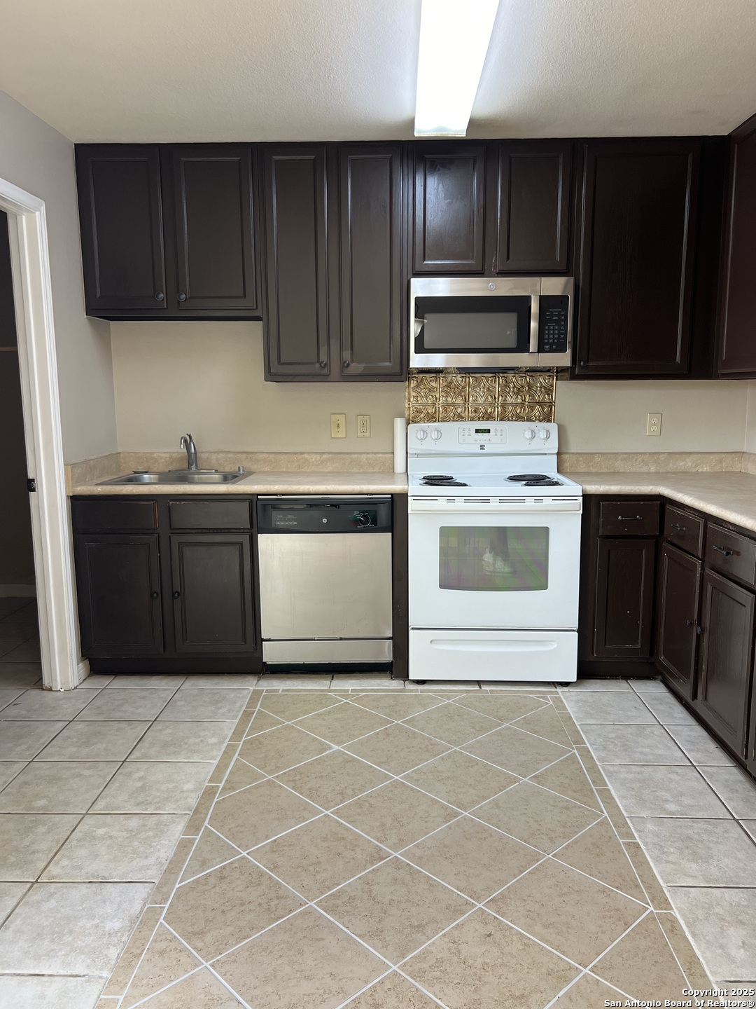 9140 Timber Path, Unit 802 San Antonio, TX 78250 - Photo 10 of 29 a kitchen with stainless steel appliances granite countertop a sink and a stove top oven with granite countertops
