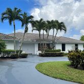 a front view of a house with a garden and a yard