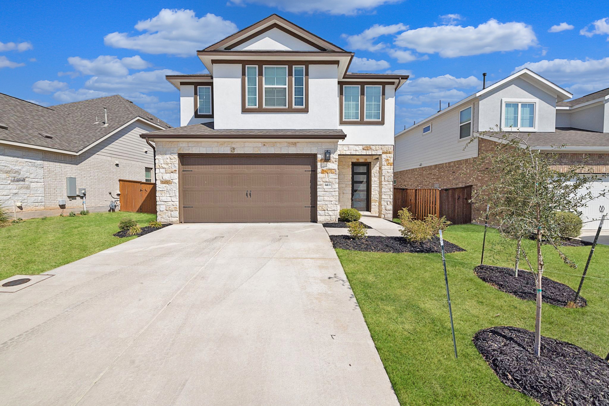 1413 Kneehigh Lane Georgetown, TX 78633 - Photo 1 of 1 a front view of a house with a yard and garage