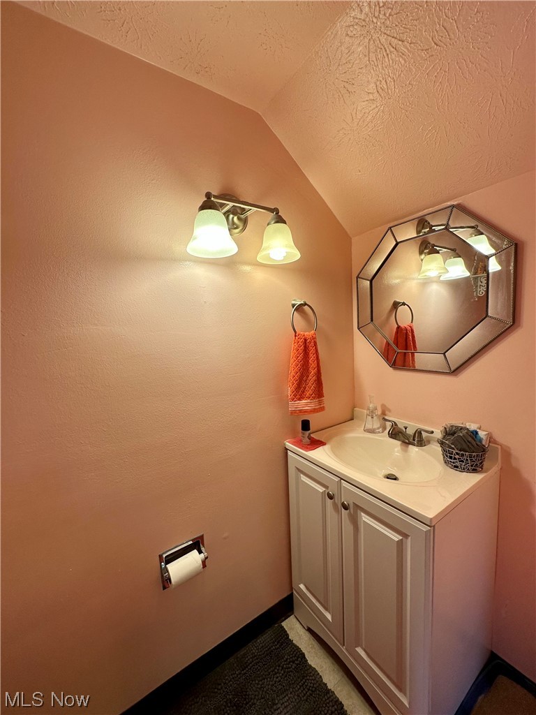 5195 Cline Road, Unit C Kent, OH 44240 - Photo 8 of 15 Bathroom with vanity, mirror, lofted ceiling, and a textured ceiling