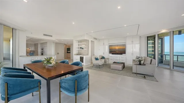 a living room with couches a coffee table and next to a window